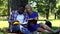 Mixed raced students making notes and looking in book, university project