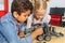 Mixed Racial group of School kids sitting at class with diy robot, stem education concept.