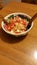 Mixed salad in bowl on table