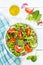 Mixed salad with fresh tomatoes healthy eating food from above portrait format on a wooden board