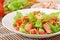 Mixed salad of fresh vegetables with pieces of salmon