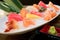 Mixed sliced fish sashimi on ice in white bowl. Sashimi Salmon Tuna Hamachi Prawn and Surf Calm set, raw fish, japanese food in