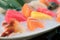 Mixed sliced fish sashimi on ice in white bowl. Sashimi Salmon Tuna Hamachi Prawn and Surf Calm set, raw fish, japanese food in