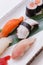 Mixed Sushi such as Hamachi, Salmon, Squid and Buri with Salmon Hosomaki