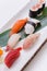 Mixed Sushi such as Toro, Hamachi, Salmon, Squid and Buri with Salmon Hosomaki