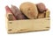 Mixed sweet potatoes in a wooden crate
