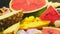 Mixed tropical fruits, closeup. Fresh fruit sliced. Background.