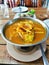 Mixed vegetable fish hot spicy Thai food yellow curry soup in hot pot