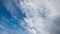 mixed white clouds on blue sky background, cloudscape time lapse, upward direction