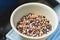 Mixed white, ruby, dark chocolate callets in a bowl