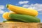 Mixed yellow and green zucchini\'s in a wooden crate