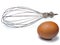 Mixer whisk and chicken egg on white background