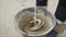 Mixing concrete plaster with electric mixer. Stir the solution in a bucket.