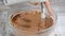 Mixing cream with chocolate to make filling or frosting