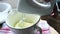 Mixing eggs, oil and milk with electric mixer