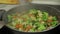 Mixing fresh vegetables on frying pan. Boiling carrots, cauliflower, broccoli