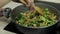 Mixing fresh vegetables on frying pan. Boiling carrots, cauliflower, broccoli