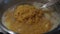 Mixing the lentil soup cooked in the pot with a colander