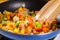 Mixing the sliced colorful vegetables on frying pan