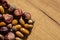 A mixture of chestnuts and acorns on the table. Natural light from the side Sharp shadows