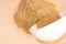 Mixture of dietary supplements. White scoop of dietary fiber on a beige background. Dietary herbal supplements, biologically