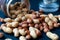 A mixture of hazelnuts and peanuts on a dark