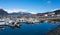 A mixture of yachts and commercial fishing boats at a coastal town in alaska