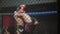 MMA fighters spar in boxing cage, blurred. Athletes in octagonal ring for fights