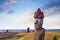 Moai heads near the Ahu Tahai Ceremonial complex on Easter Island, against a colorful sky.