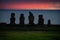 Moai shilouettes in the Ahu Tahai at sunset against pink sky