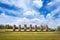 Moai statues at the Ahu Akivi Ceremonial complex on Easter Island, against a blue sky.