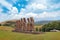 Moai statues at the Ahu Akivi Ceremonial complex on Easter Island, against a blue sky.