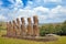 Moai statues at the Ahu Akivi Ceremonial complex on Easter Island, against a blue sky.