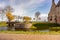 Moat with its bridge, cannons and bare trees in the background, partial view of Radboud castle