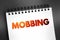 Mobbing - sociological term, means bullying of an individual by a group, text on notepad