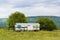 Mobile apiary trailer in meadow. View of Adygea republic nature, Russia