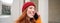 Mobile broadband and people. Smiling young redhead woman walks in town and talks on mobile phone, calling friend on