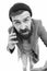 Mobile call concept. Important conversation. Man bearded hipster hold mobile phone white background. Stylish guy use