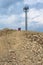 Mobile communications site at the top Big Sky Resort, with people walking on the trail to t