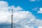 Mobile communications tower on the sky background. Large clouds. Aerials of cellular communication. GSM Tower. Covering mobile.