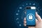 Mobile device security system. Hand holding mobile smart phone with lock and application icons. on blue background with copy space