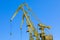 Mobile harbor cranes over blue sky. Transport and technology concept