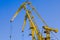 Mobile harbor cranes over blue sky. Transport and technology concept