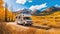A mobile home stands next to a mountain road in bright autumn. Autumn vacation in a camper