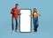 Mobile Offer. Cheerful Arab Couple Pointing At Big Cellphone With White Screen