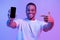 Mobile Offer. Joyful Black Man Pointing At Smartphone With Blank Screen