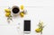 Mobile phone ,black coffee espresso with yellow flower ylang ylang ,purple flowers in spring
