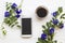 Mobile phone ,Black coffee with flower butterfly pea local flora of asia