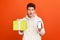 Mobile phone bonuses. Excited surprised young man in casual sweater with hood holding gift box and smartphone with blank display