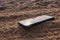 Mobile phone buried in the grey sand, lose your smartphone on the beach while on vacation a